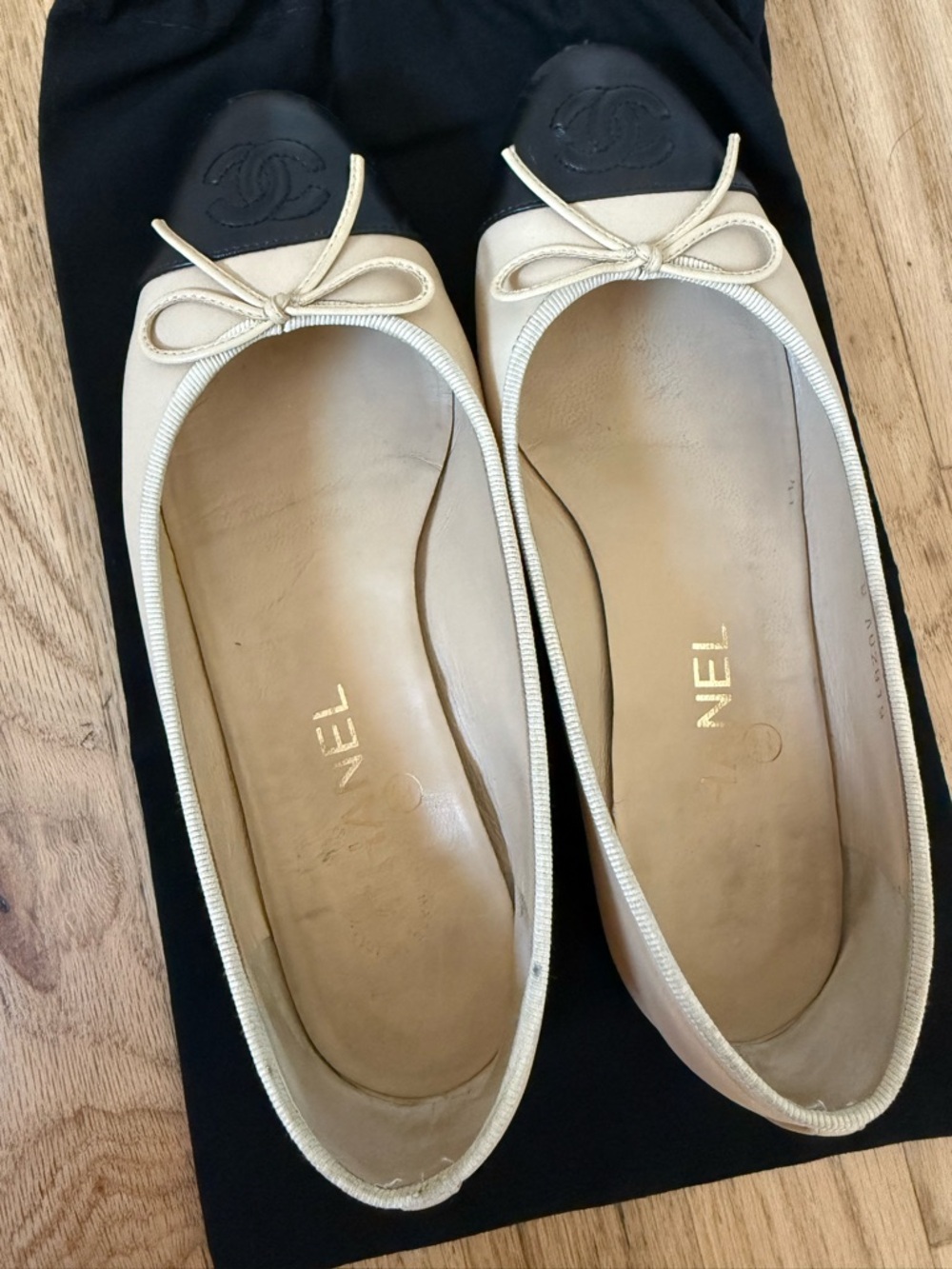 CHANEL Beige Leather Ballet Flats with Black Cap Toe and Bow